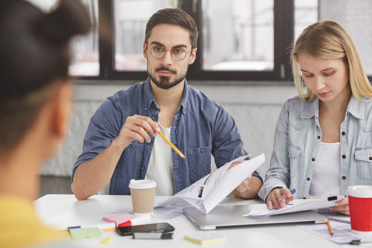 young-colleagues-have-formal-meeting-discuss-solutions-study-documents-prepare-marketing-project-min.jpg
